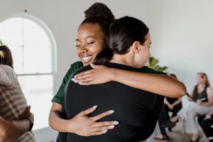 women hugging eachother in rehab
