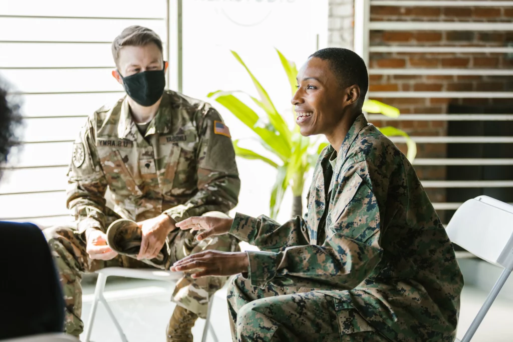 military woman smiling during group therapy