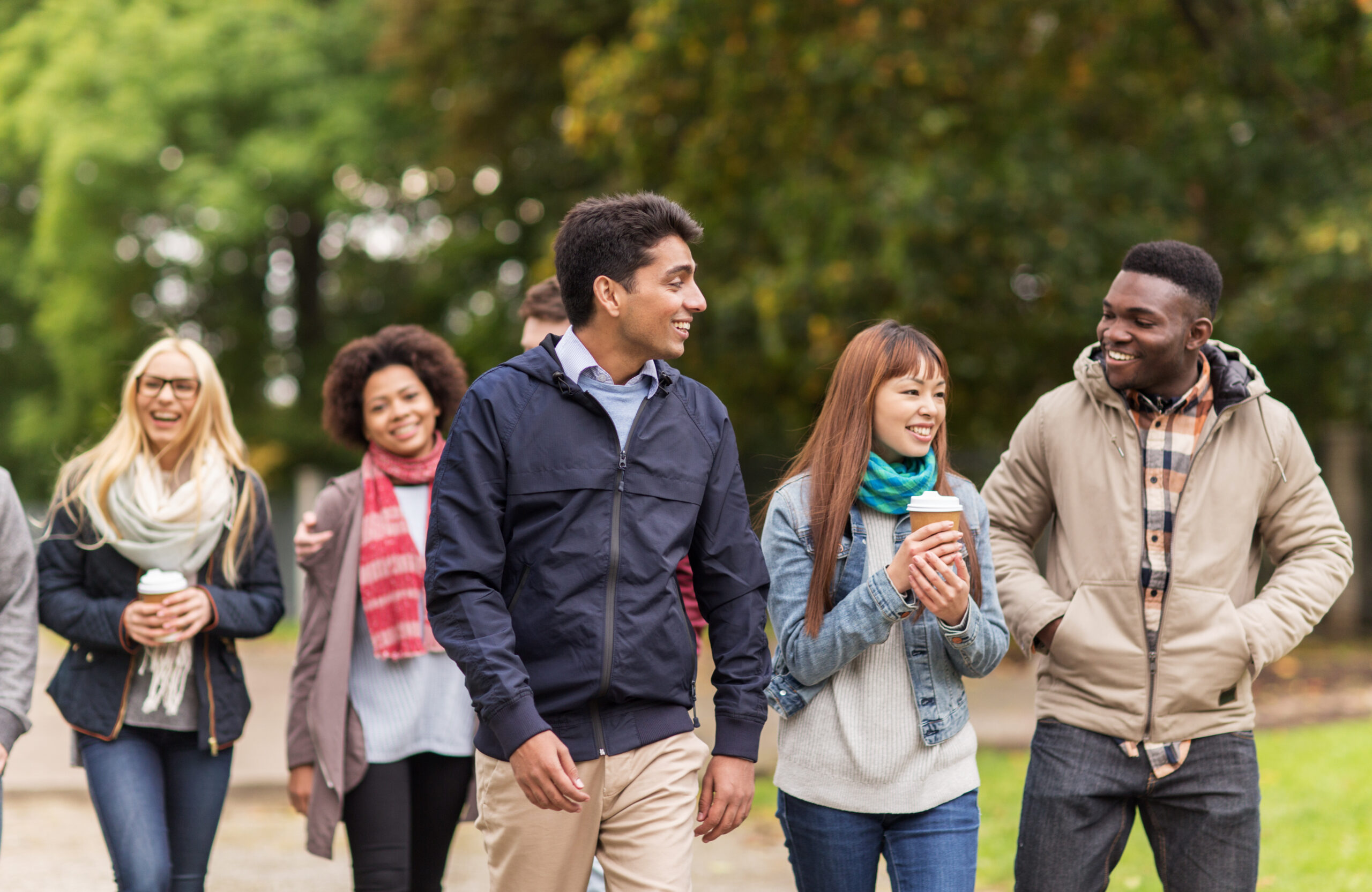 happy friends walking along autumn park