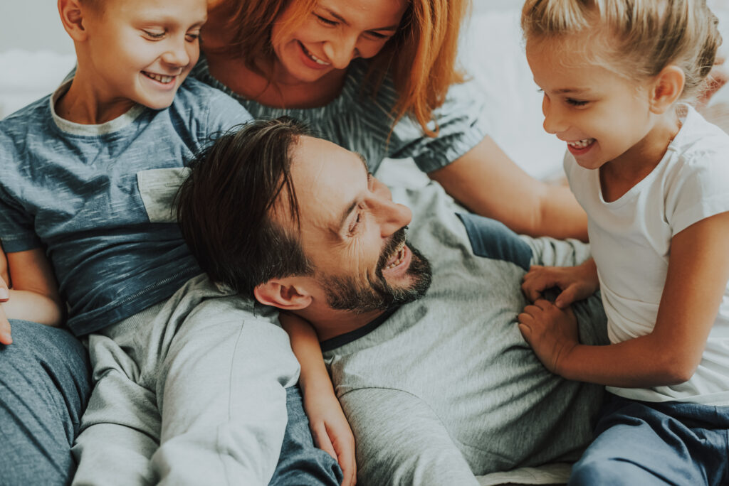 Happy parents and two kids having fun together