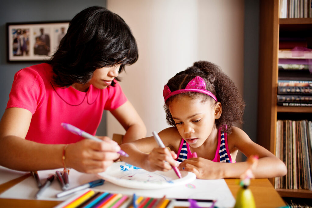 View of mother and daughter drawing