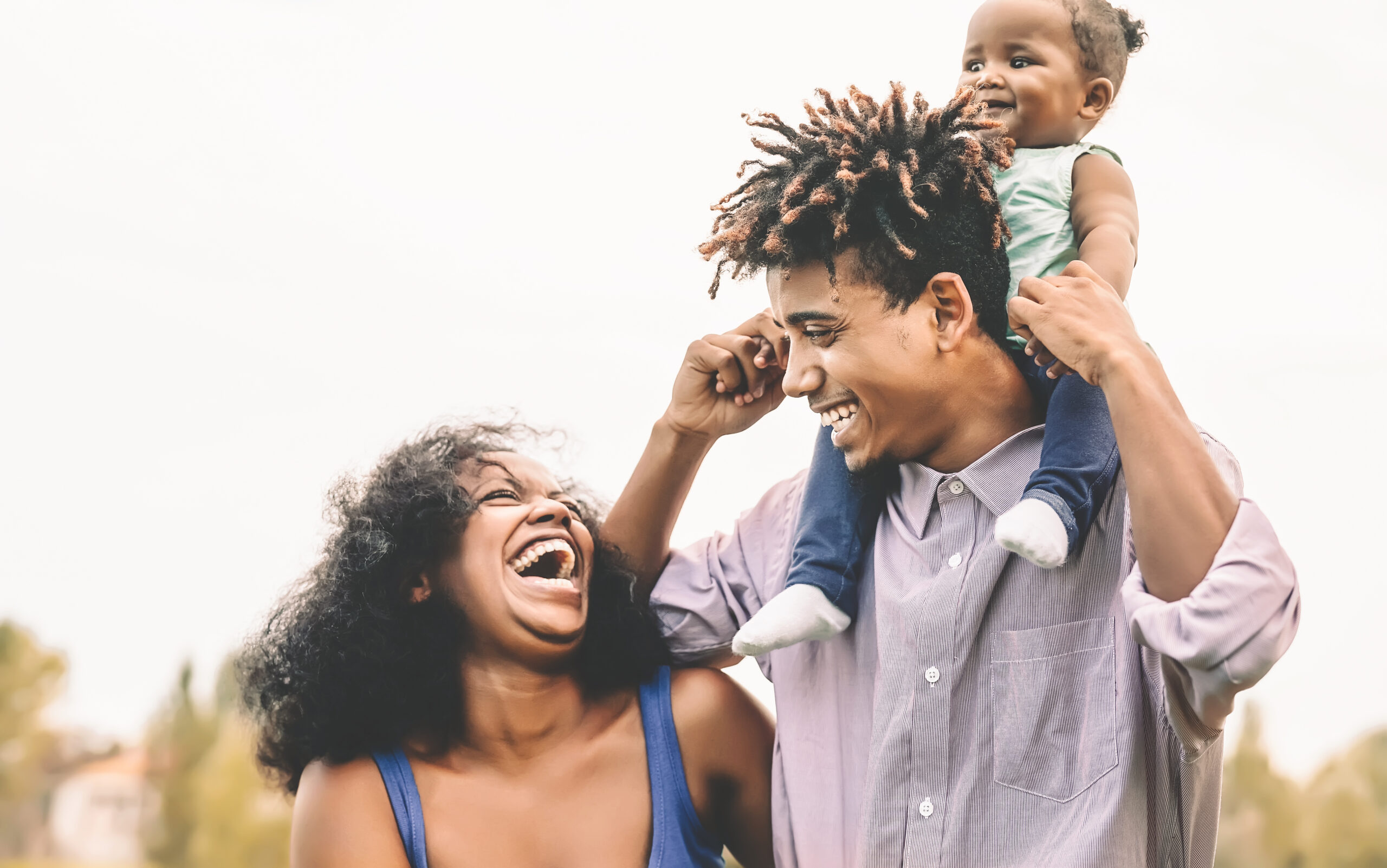 Happy African family having fun in public park