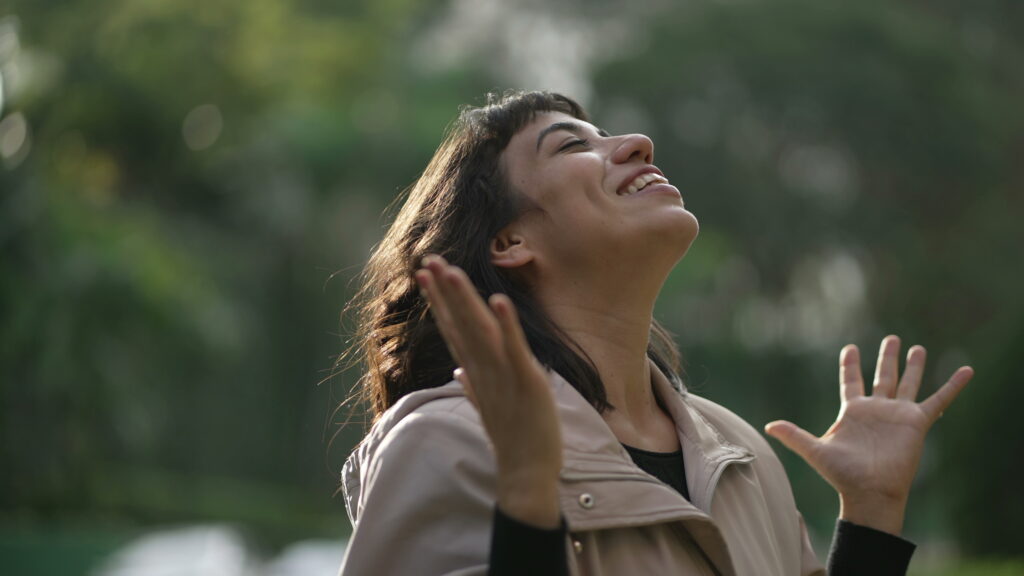 South American woman standing, praising God