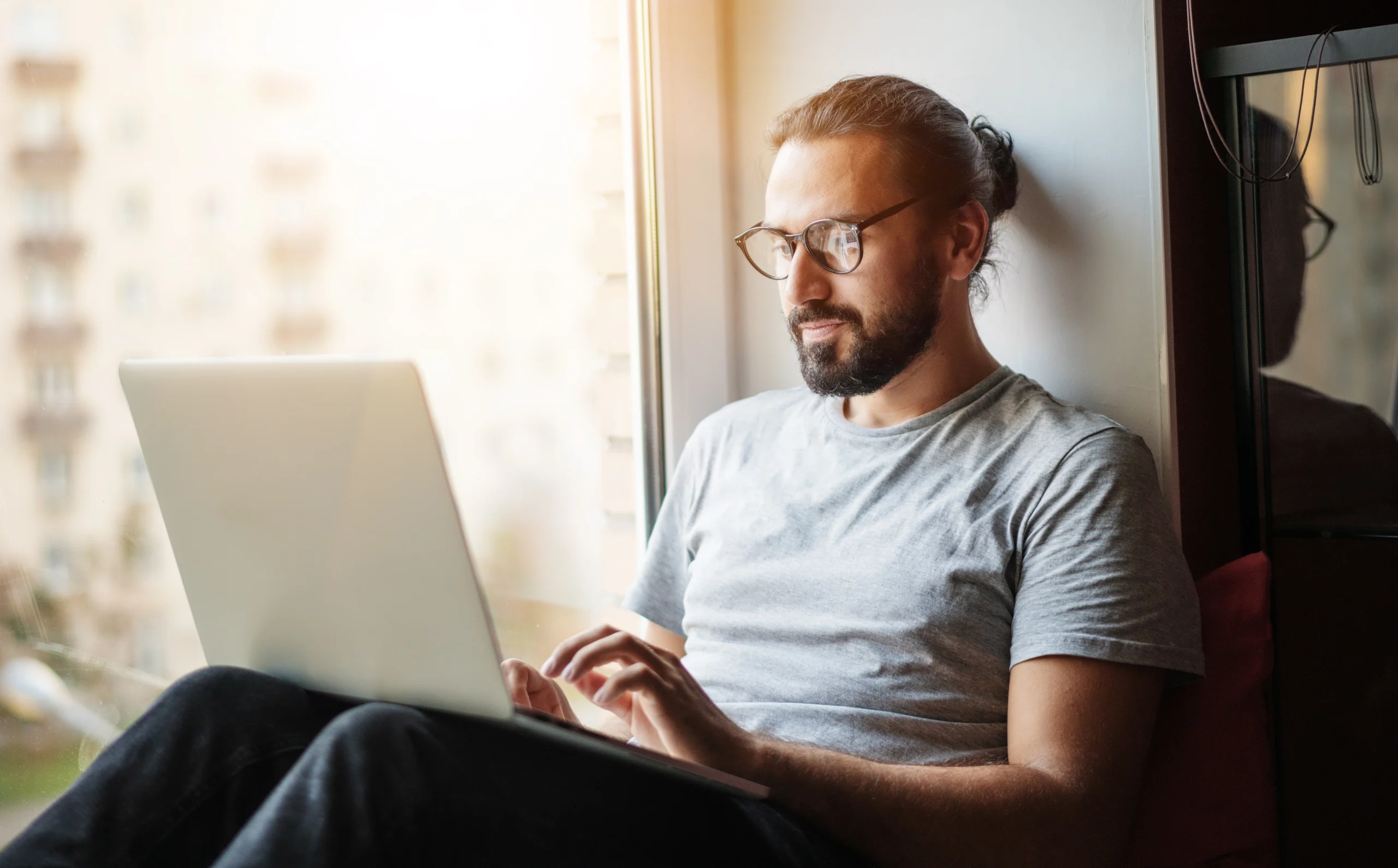 man on laptop taking online classes