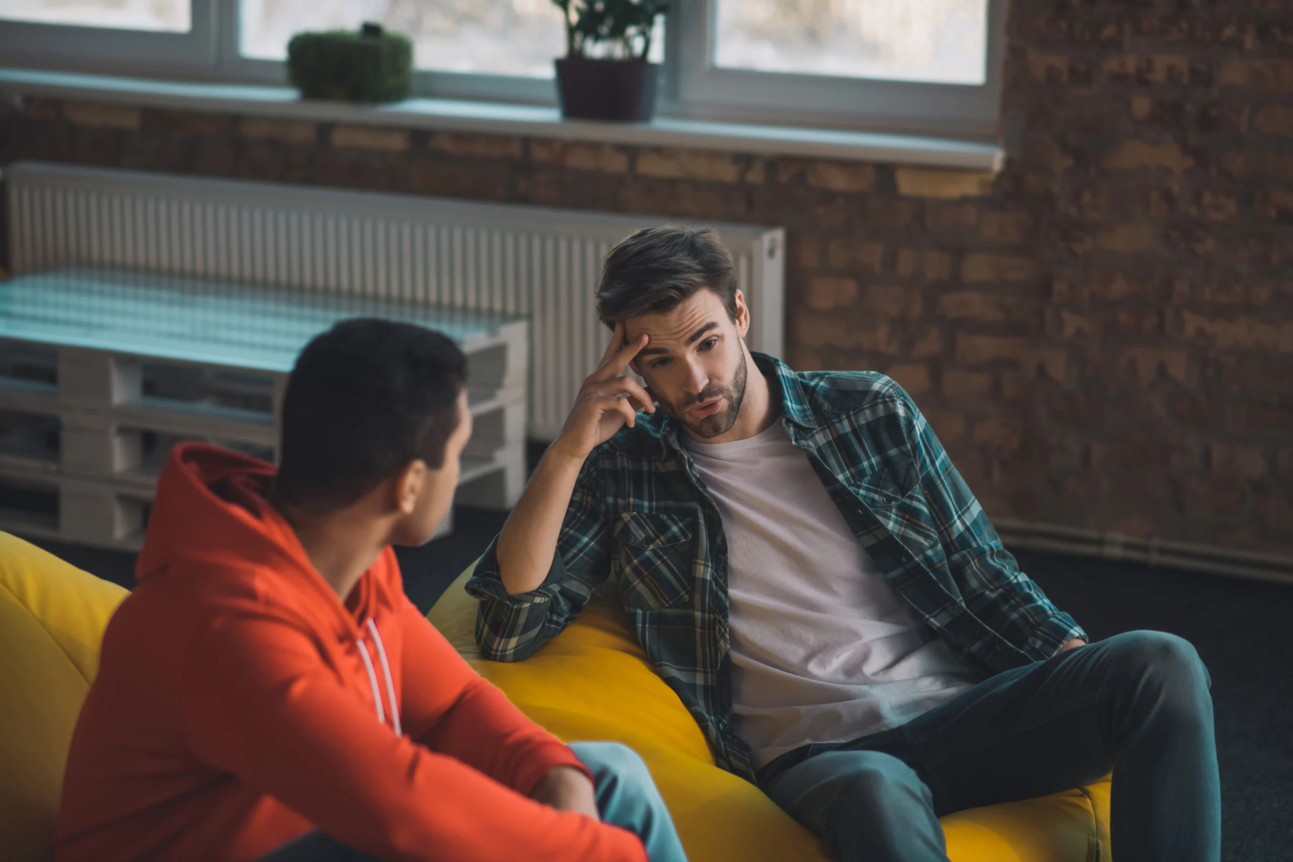 two men sitting together counseling eachother