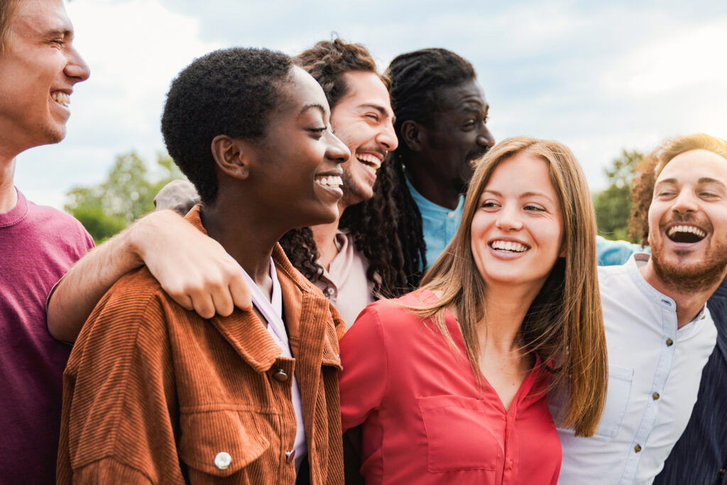 group of diverse friends having fun outdoors at addiction treatment center